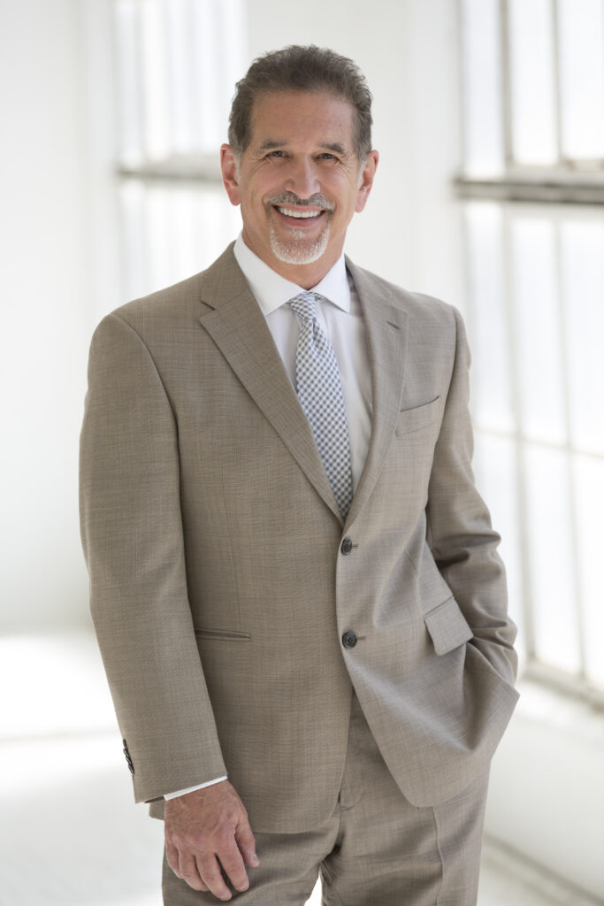 Consumer Advocate Tom Martino standing and smiling